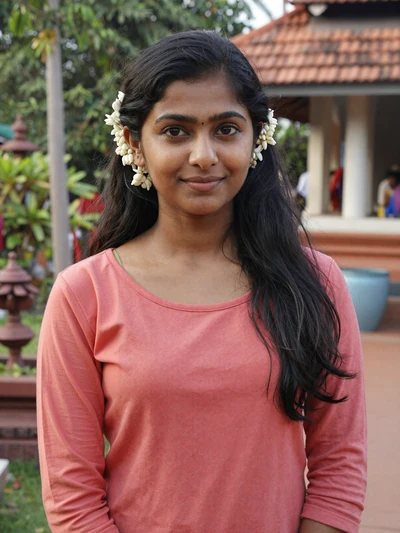 Meera, 26, Tamil woman from Chennai near temple garden with jasmine flowers, looking for genuine love