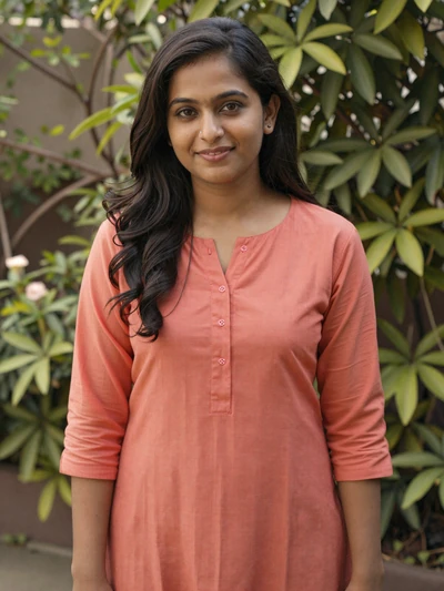 Priya, 28, Indian woman from Bangalore smiling warmly in a lush garden setting