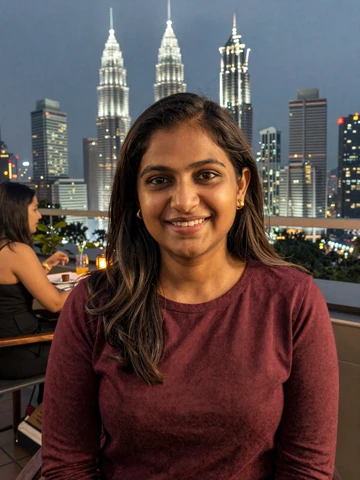 Indian Malaysian woman at rooftop restaurant in Kuala Lumpur evening setting, representing modern multicultural Malaysian dating scene