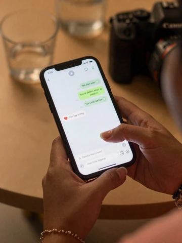 Smartphone showing a dating app conversation with thoughtful first messages for Asian dating
