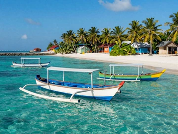 Traditional Maldivian fishing boats at island harbor in turquoise waters, representing the fishing culture central to Maldivian identity and dating values