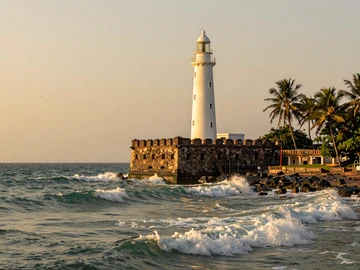 Galle Fort lighthouse in Sri Lanka at golden hour with ocean waves, representing romantic Sri Lankan coastal heritage