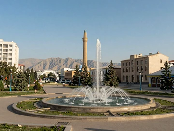 Dushanbe Tajikistan city center with Rudaki Park fountain and Fann Mountains in background, showcasing modern Tajik urban culture