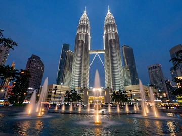 Petronas Twin Towers illuminated at twilight in Kuala Lumpur Malaysia, iconic landmark for romantic Malaysian dating