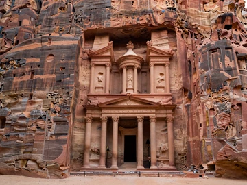 The ancient Treasury at Petra Jordan carved in rose-red sandstone at golden hour, representing Jordan's rich cultural heritage